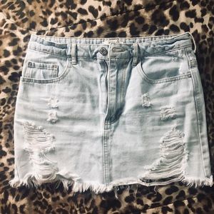 Distressed denim mini skirt
